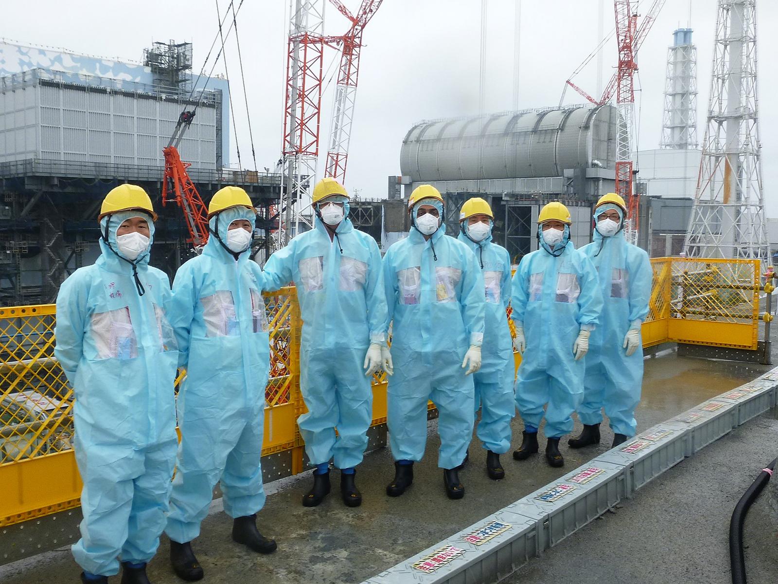 Group of visitors in front of Daiichi Nuclear Reactor in Fukushima Japan