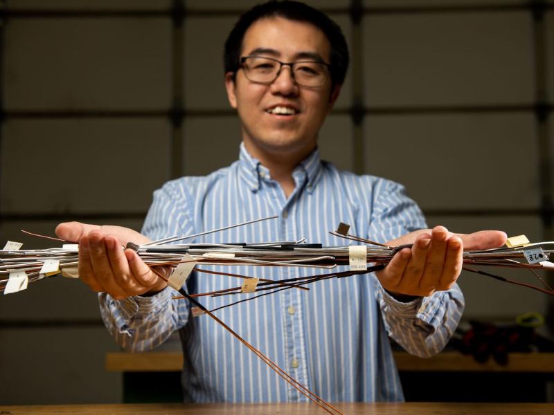 Man showing copper wire samples