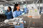 Pacific Northwest National Laboratory microbiologists Sarah Fansler (left) and Vanessa Bailey use instruments at PNNL's Biological Sciences Facility to study microbes that typically live in soils.