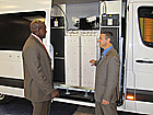 Craig Nelson, right, shows radiation detection equipment inside a specially equipped van an attendee at an INTERPOL conference in May.