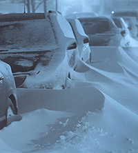 cars covered with snow drifts during cold snap