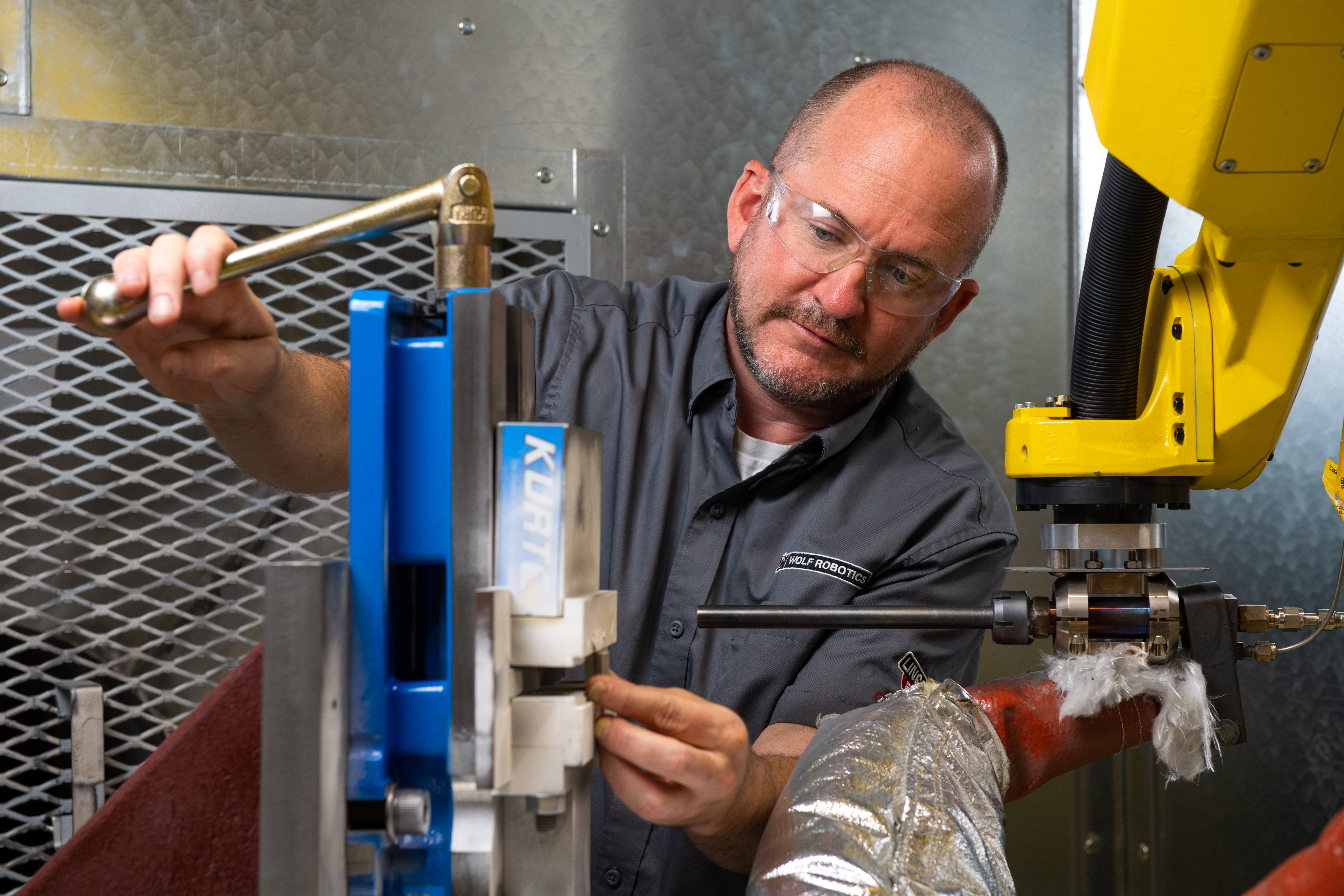 Researcher holding cold spray component.