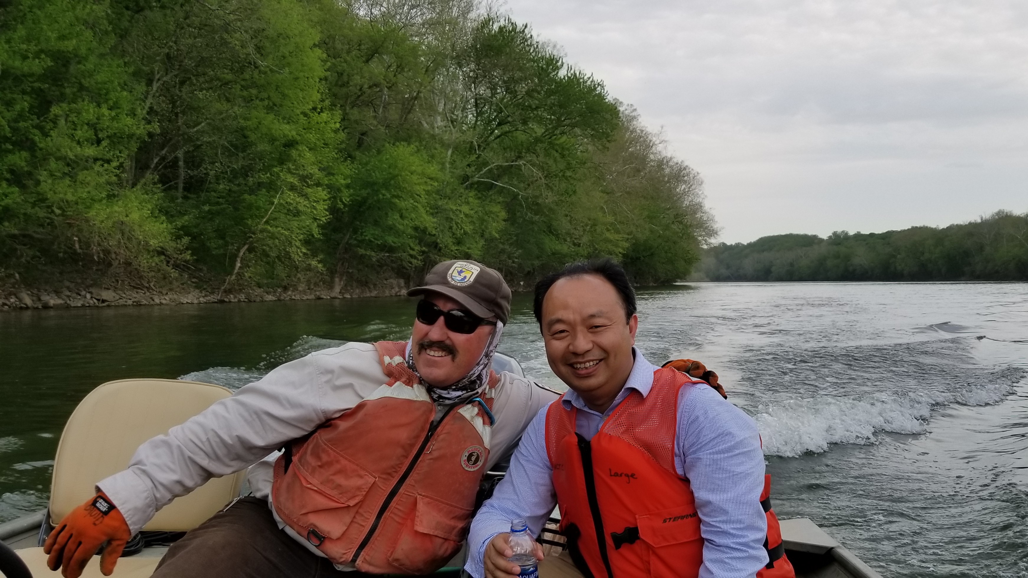 Zhiqun (Daniel) Deng deploying instruments with collaborator of the U.S. Fish and Wildlife Service to study American eels on the Potomac River