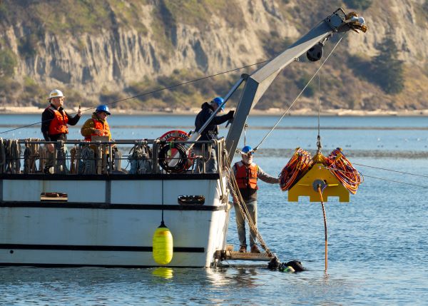 The CRABEE research node apparatus being lowered into the water of Sequim Bay from the back of a research vessel