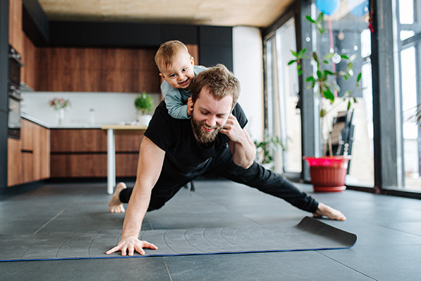 dad doing pushup with child on his back