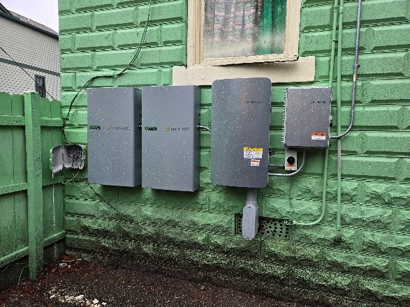 Electric boxes attached to wall.