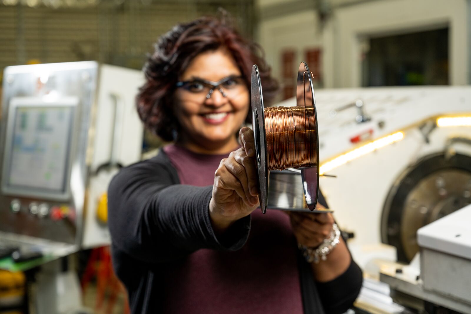 Keerti Kappagantula shows a roll of copper wire