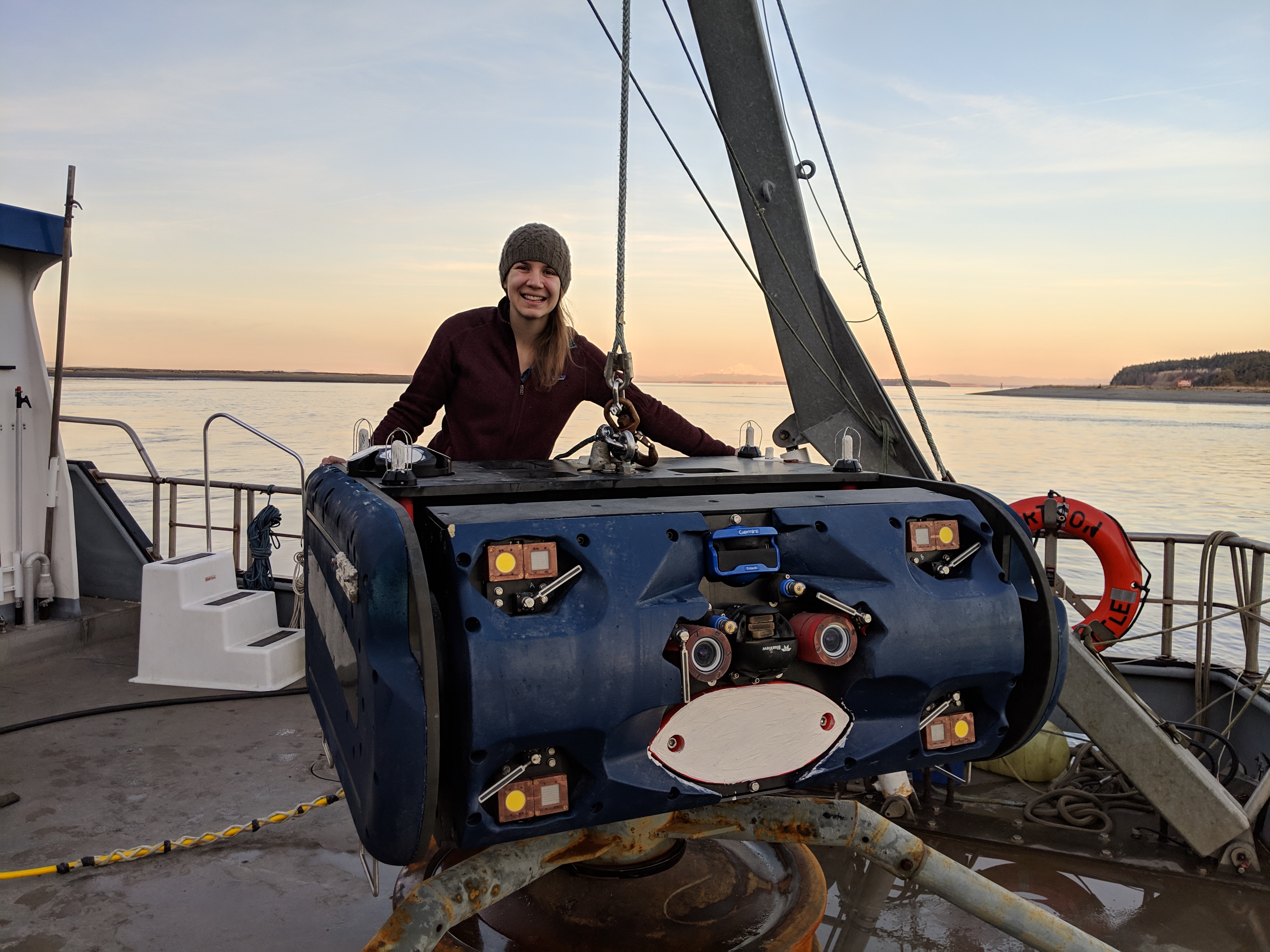 Emma Cotter standing next to the UW AMP