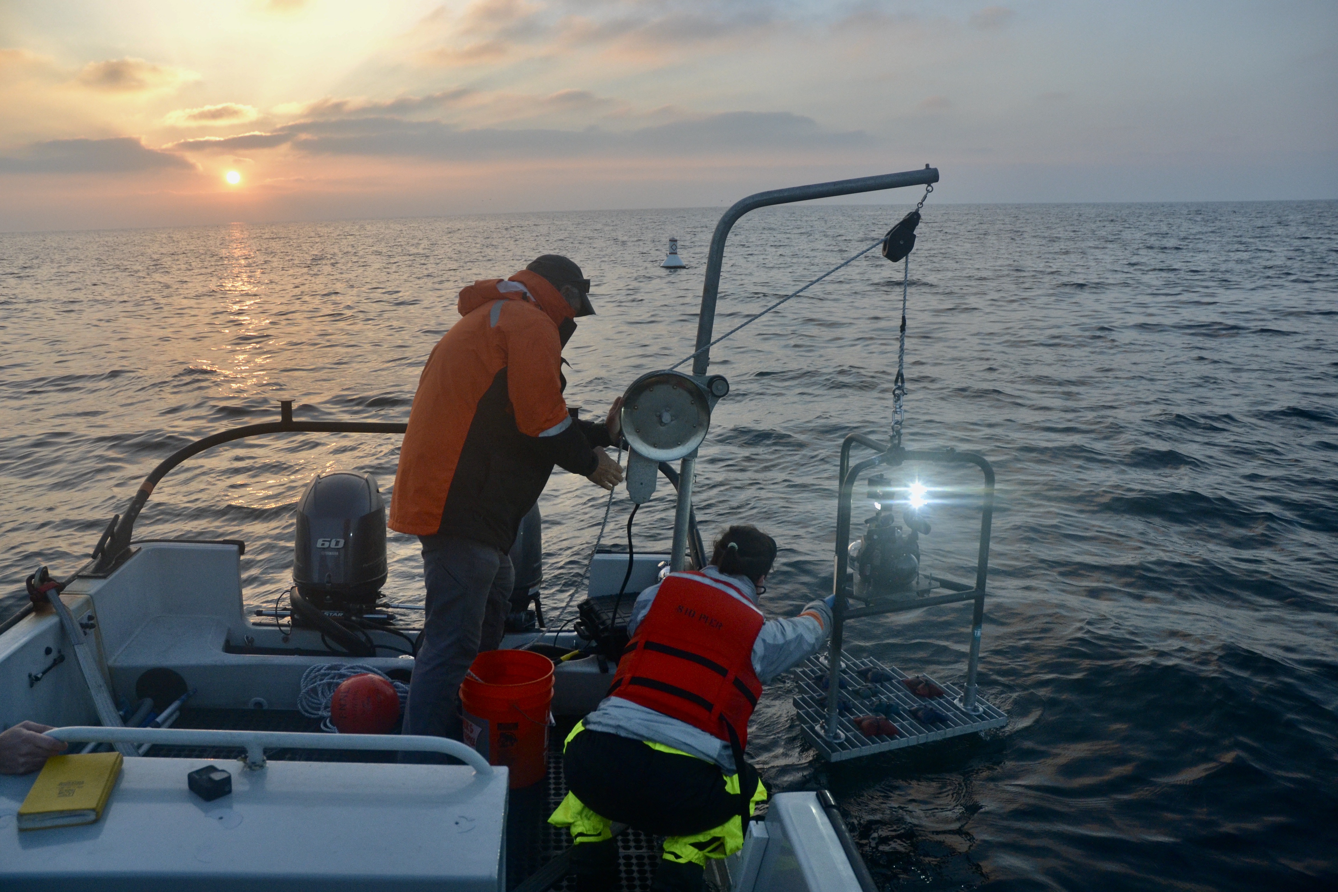 Hemery deploying the Boxfish camera off the boat at sunset. 