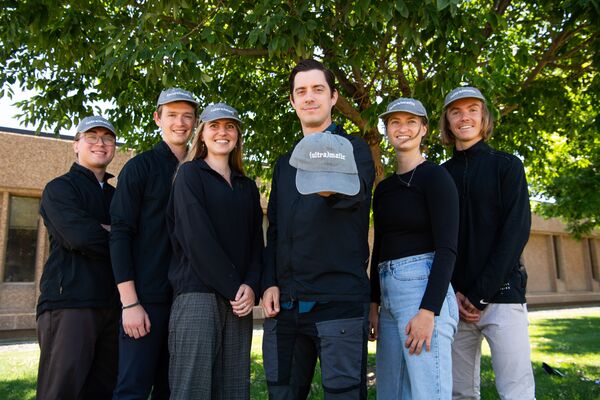 Photograph with Quin Miller in the center, surrounded by summer interns