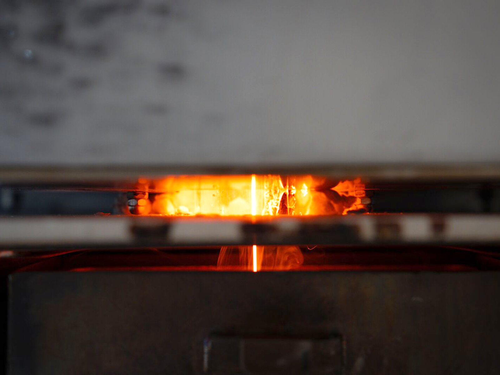 Molten glass being poured from melter.