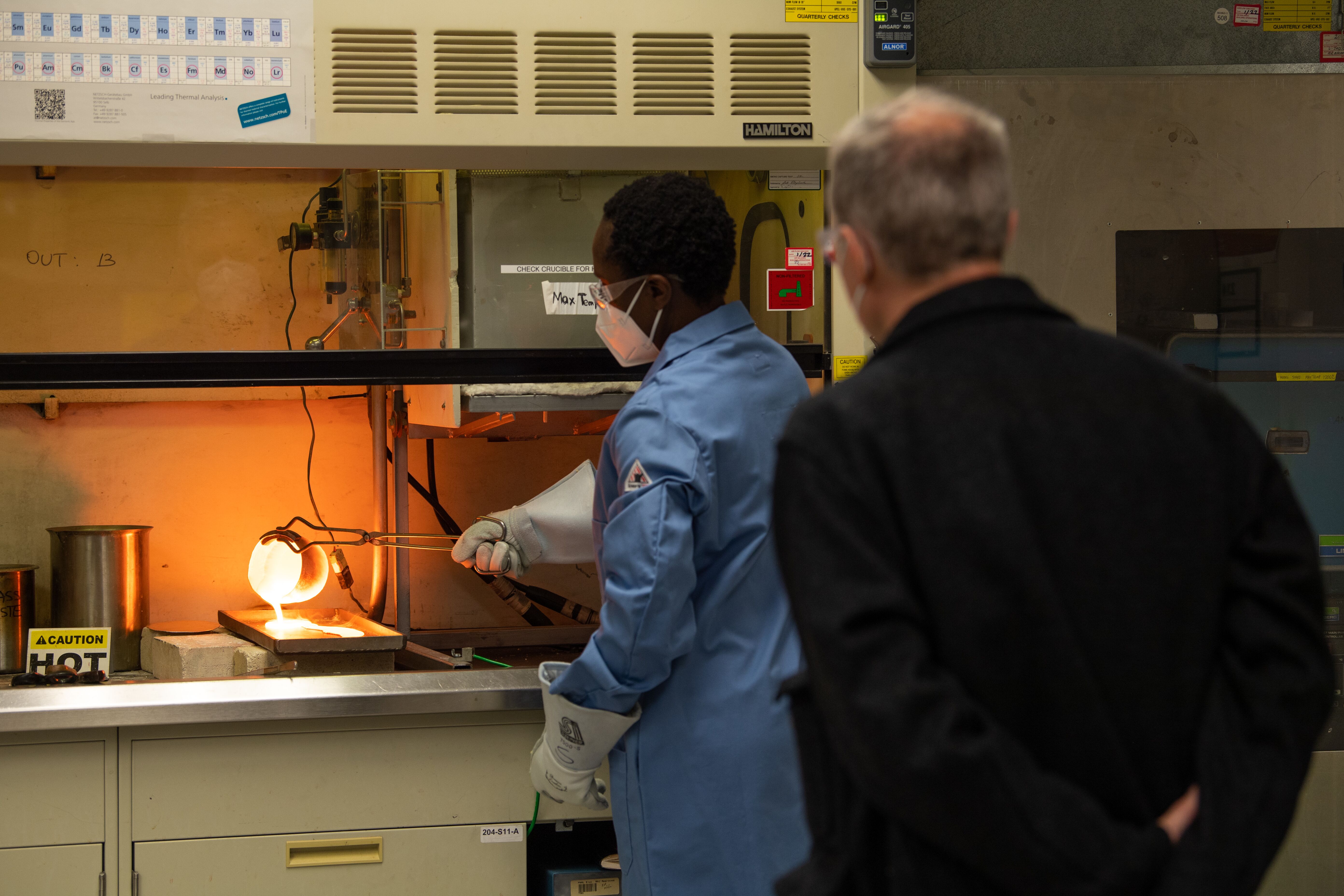 Materials scientist Charmayne Lonergan pours melted glass in a demonstration of how glass can be used to encase radioactive waste