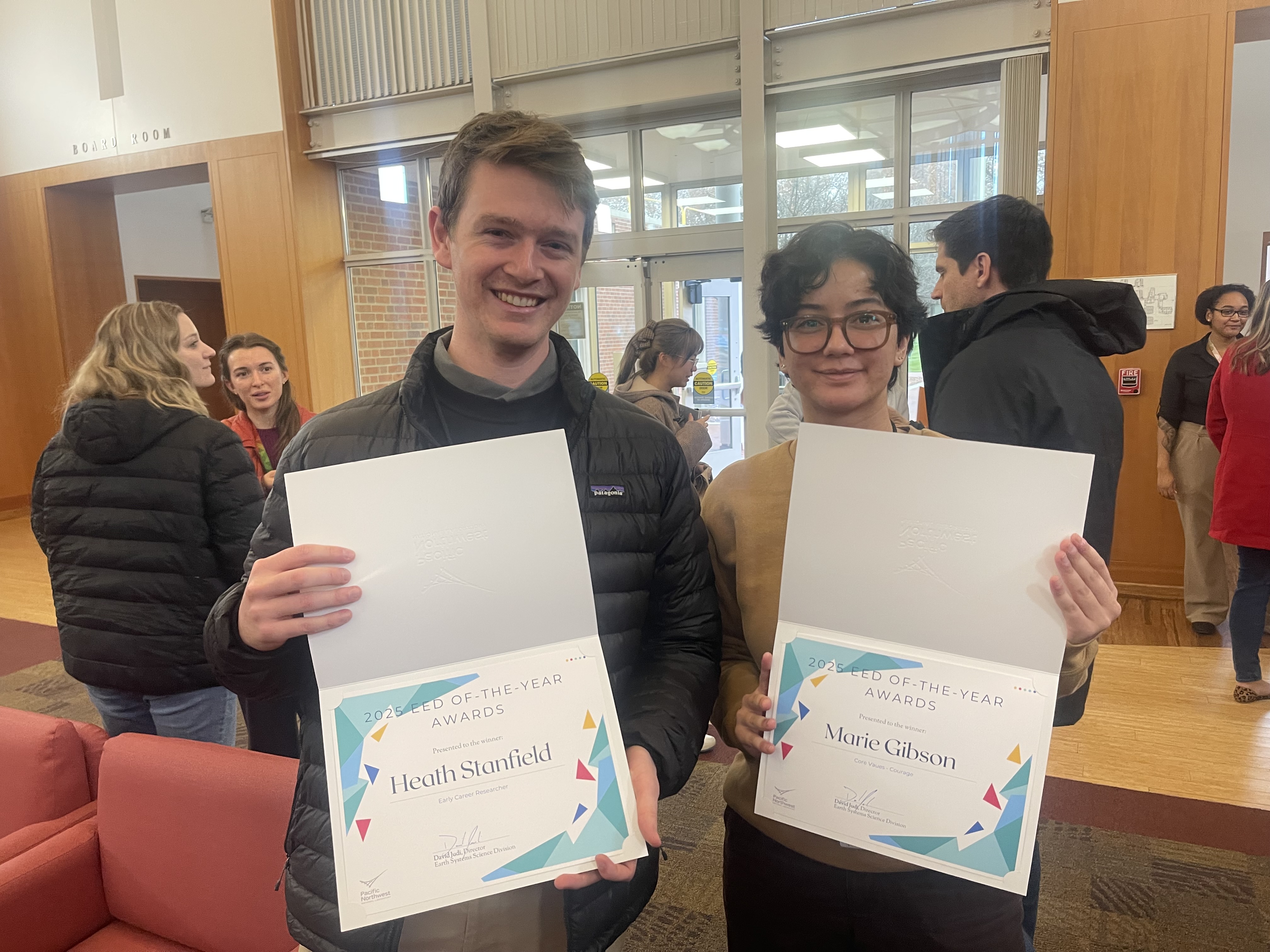 Photograph of Heath Stanfield (left) and Marie Gibson (right) holding EED OTY awards.
