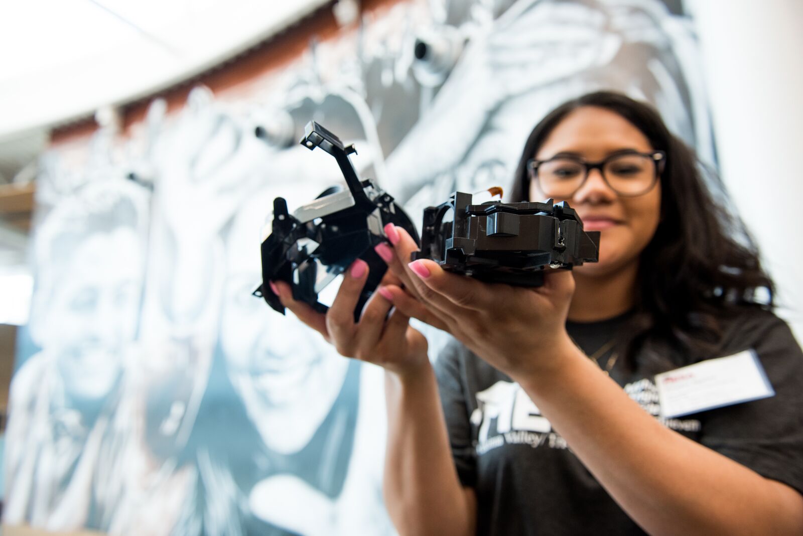 A student holding machinery