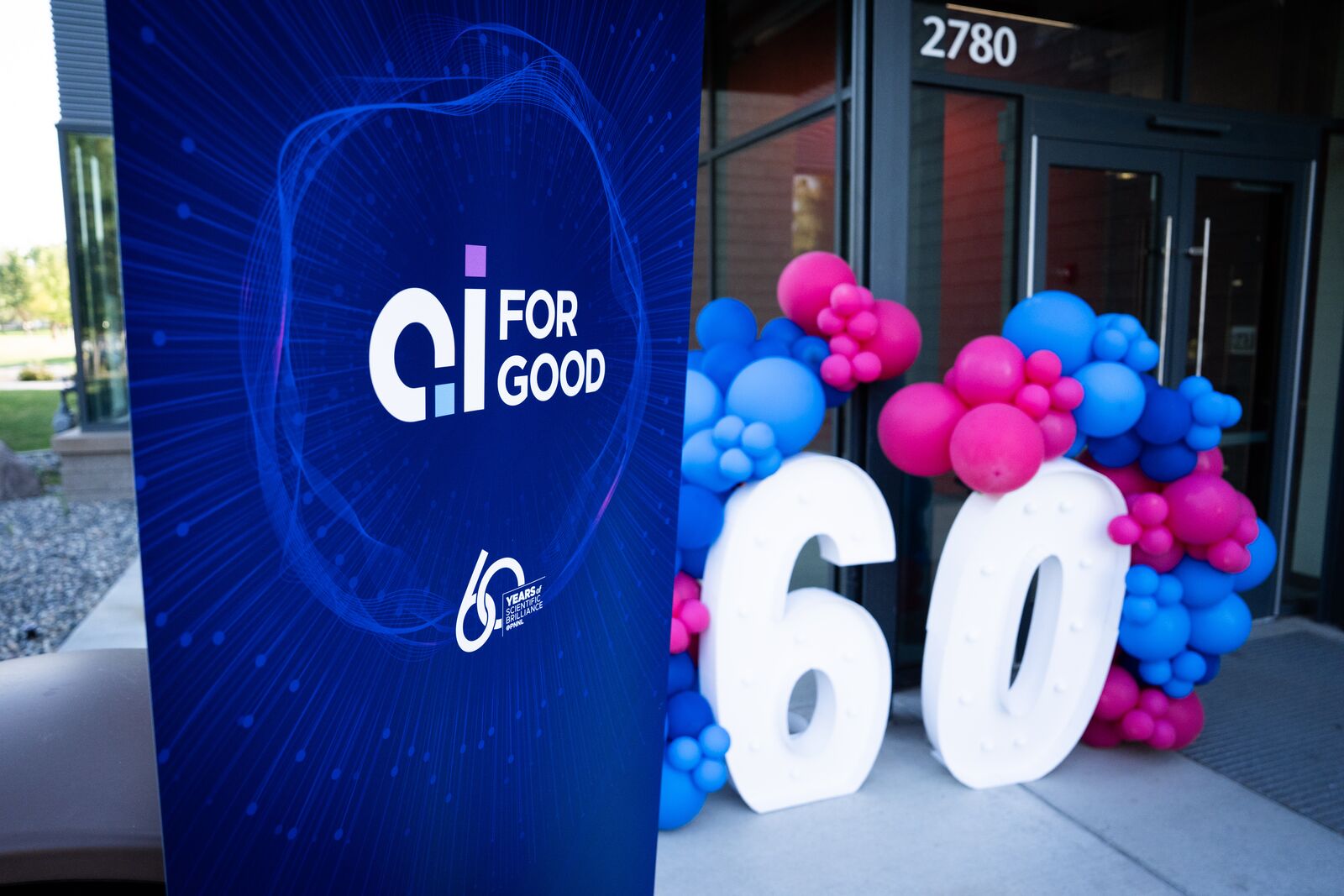 balloons in the shape of 60 and a sign saying AI for Good 