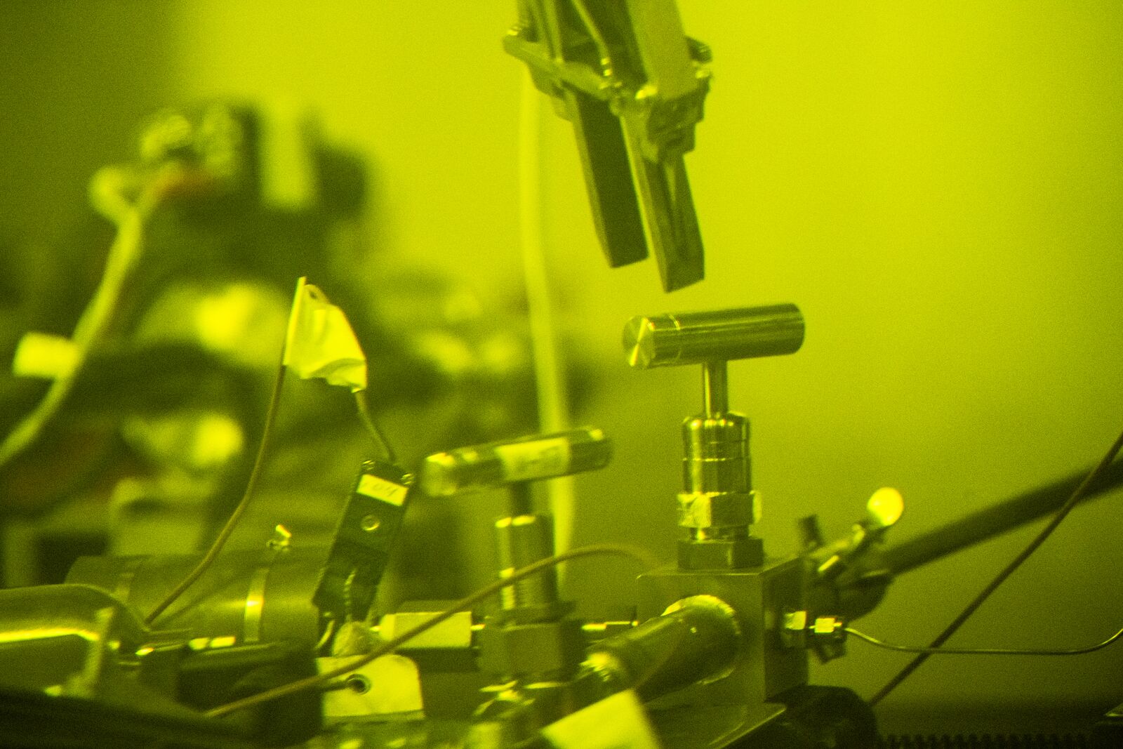 Scientists examine nuclear fuel rods in a radiochemical processing laboratory.