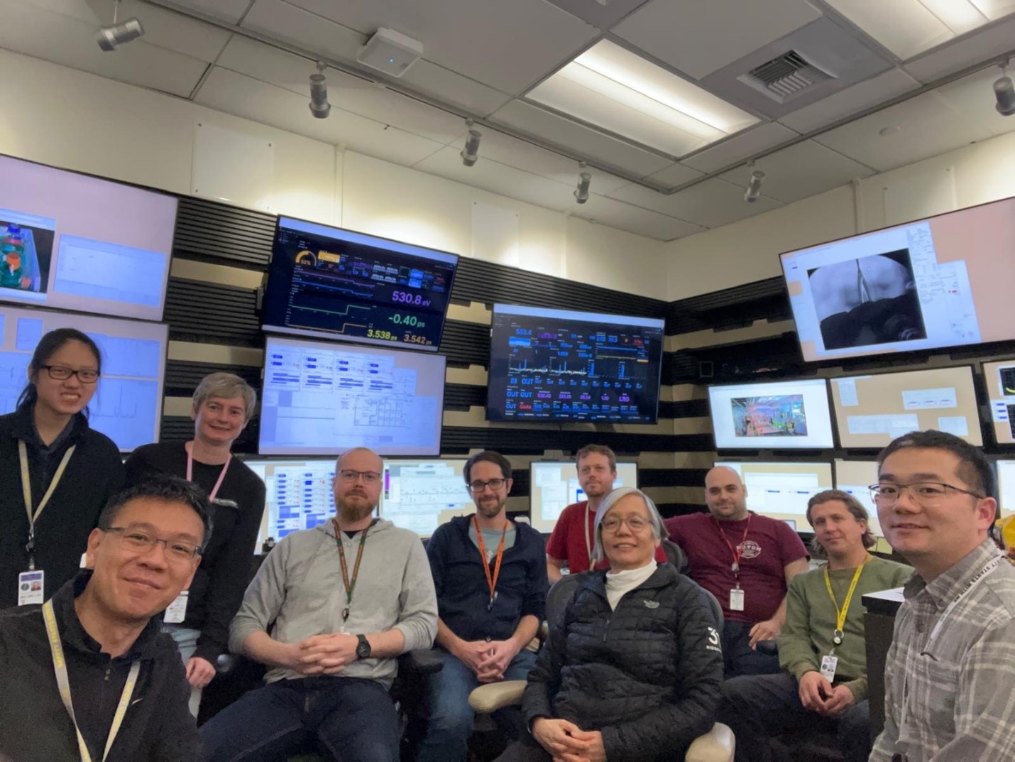 A group of scientists in front of computer monitors at the SLAC National Accelerator Laboratory