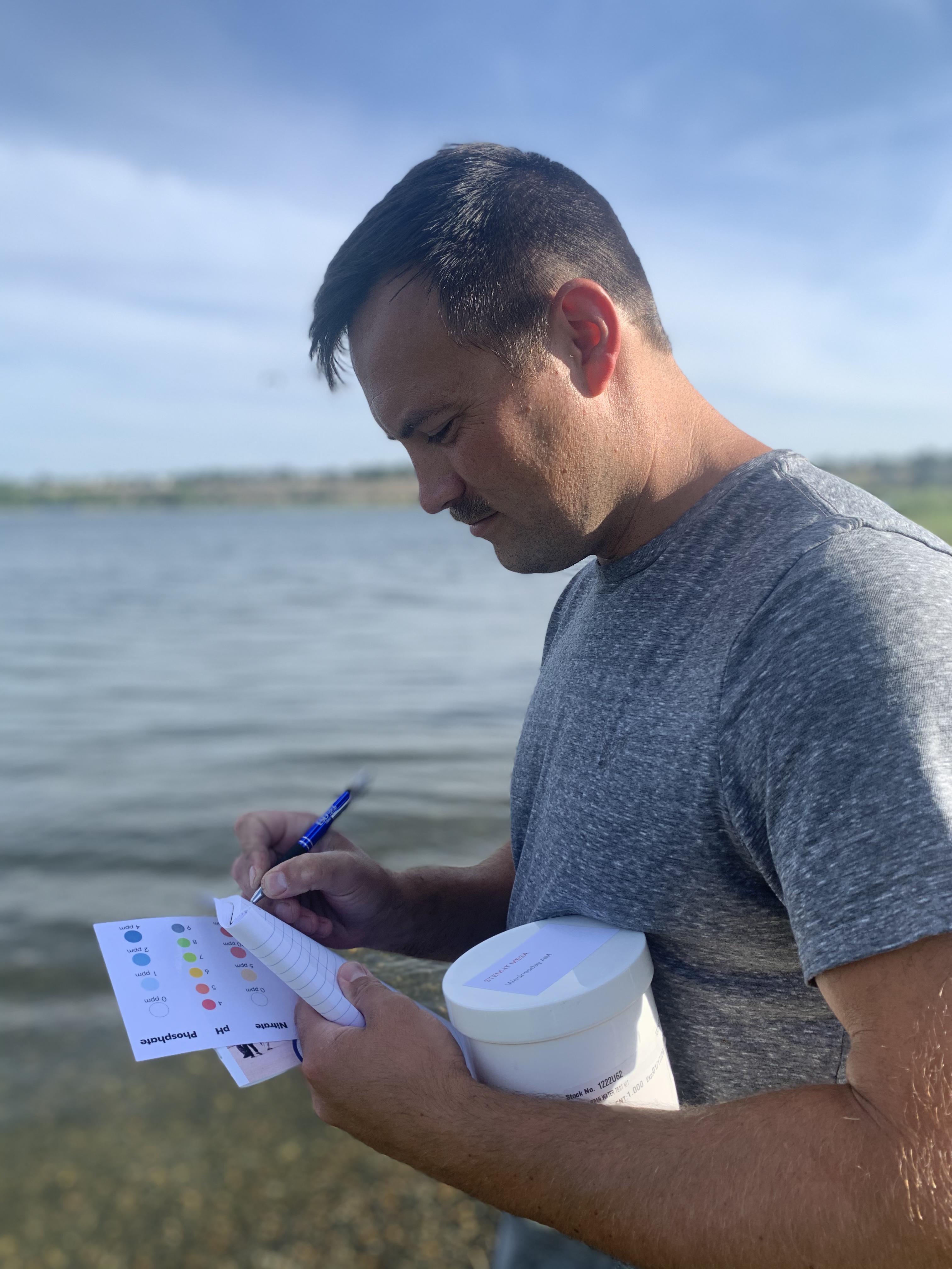 Teacher takes notes by river