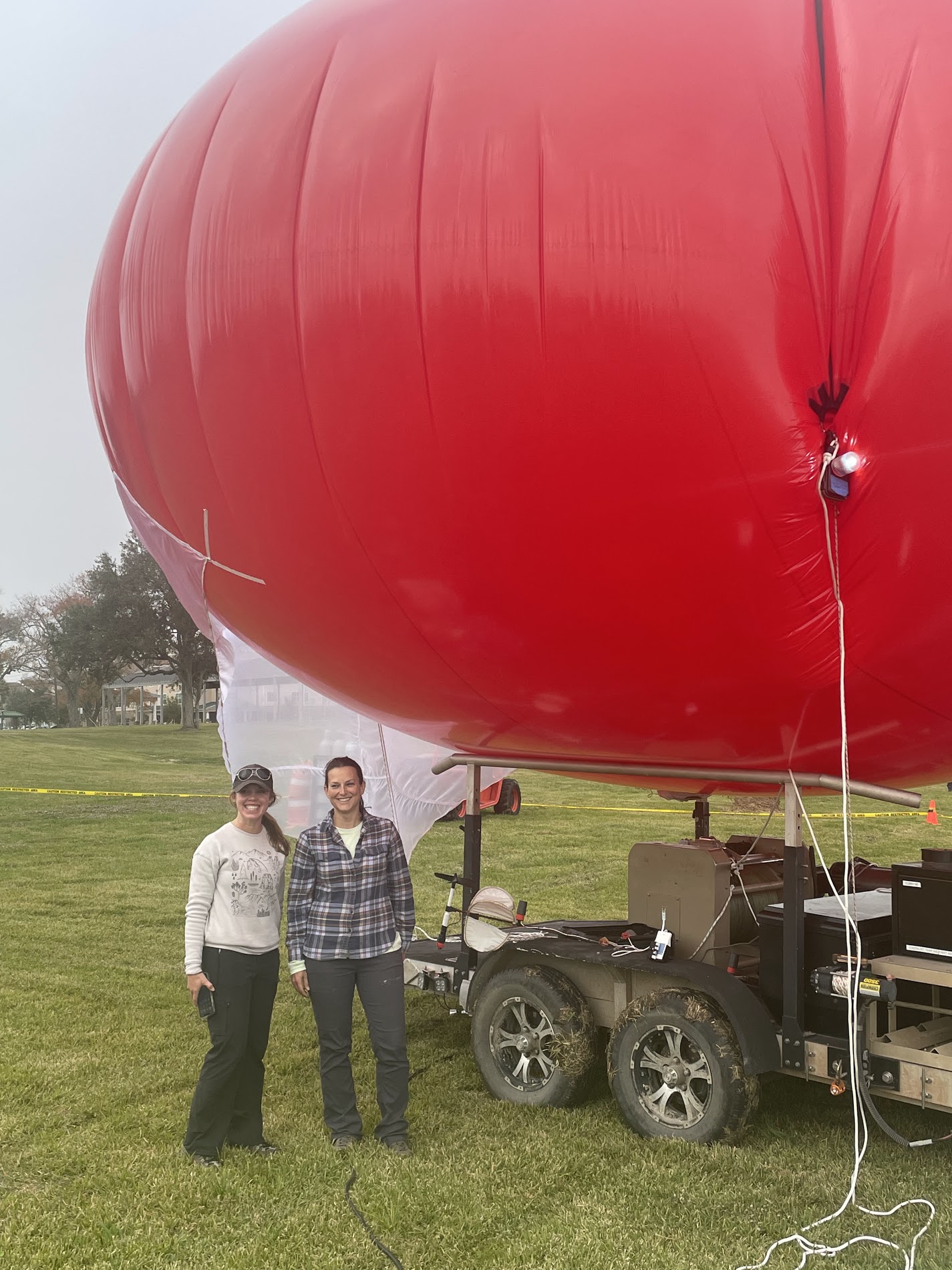 The team smiling next to the tethered balloon system.