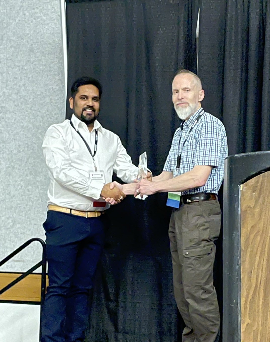 Piyoosh Jaysaval stands next to Fred Day-Lewis posing with award