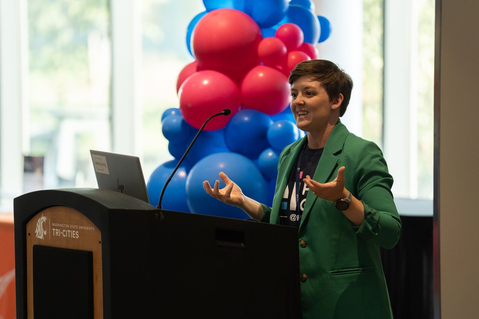 a woman speaks at a podium