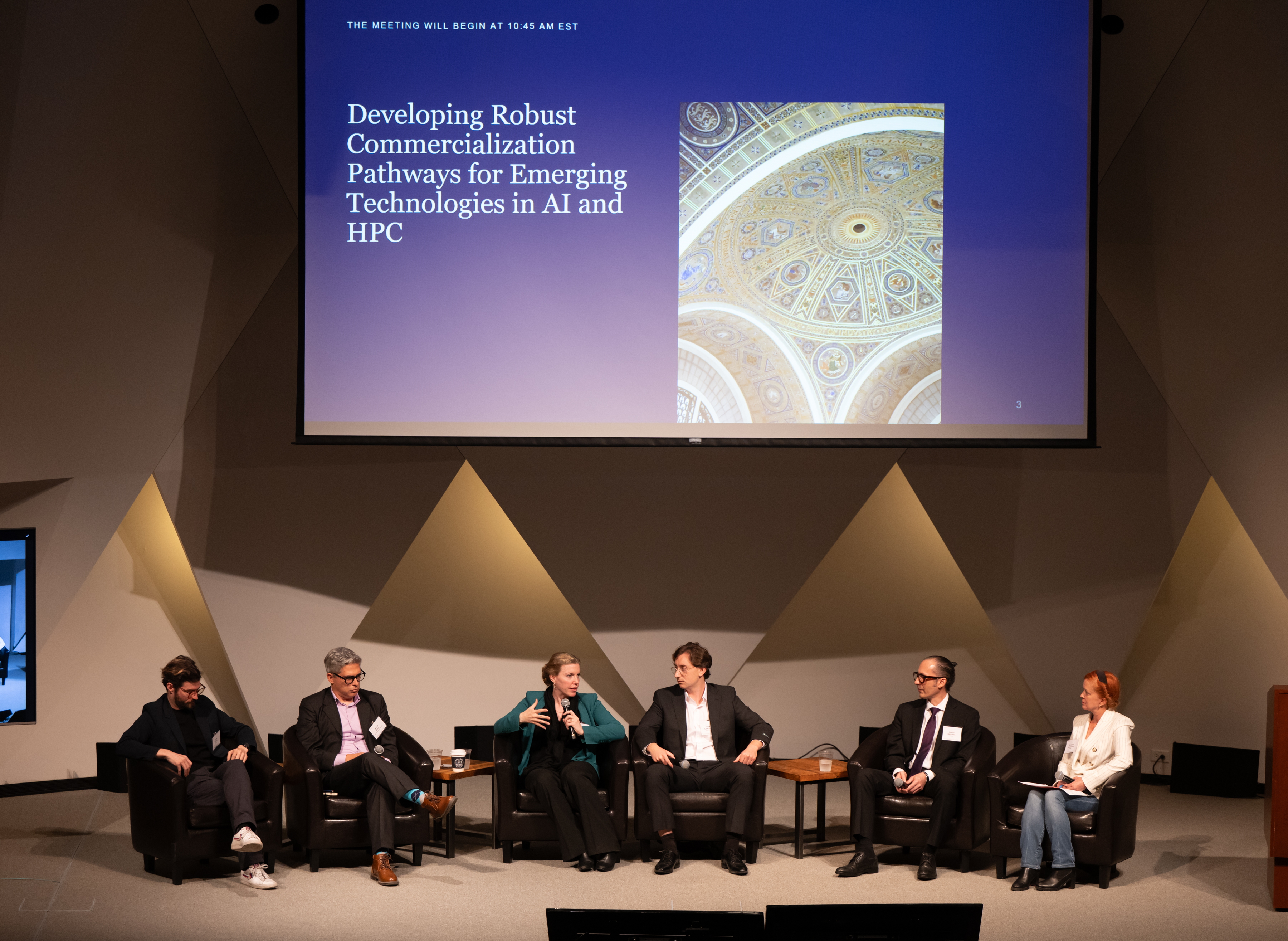 Panelists sit in semi circle and talk to one another