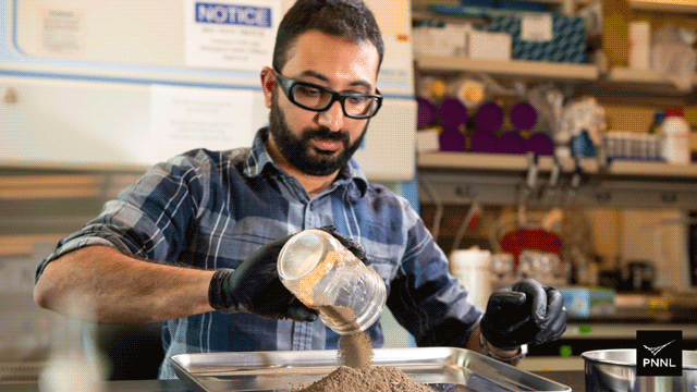 Gif of an Asian man pouring soil from a glass jar onto a metal tray