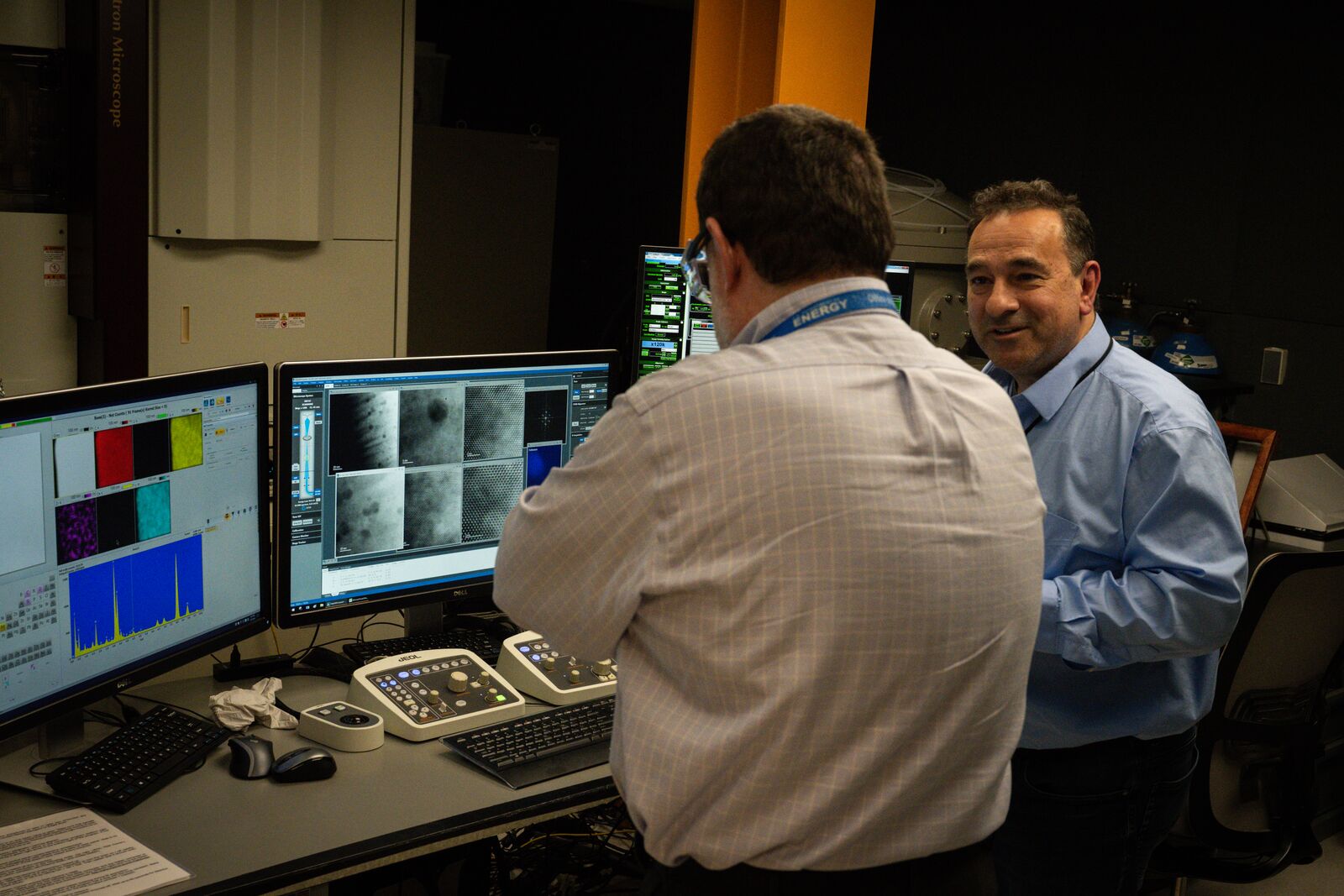 Researcher Edgar Buck explains how a high-power microscope in a protected underground lab is used to analyze nuclear materials to DOE Nuclear Energy leader Dr. Mike Goff.