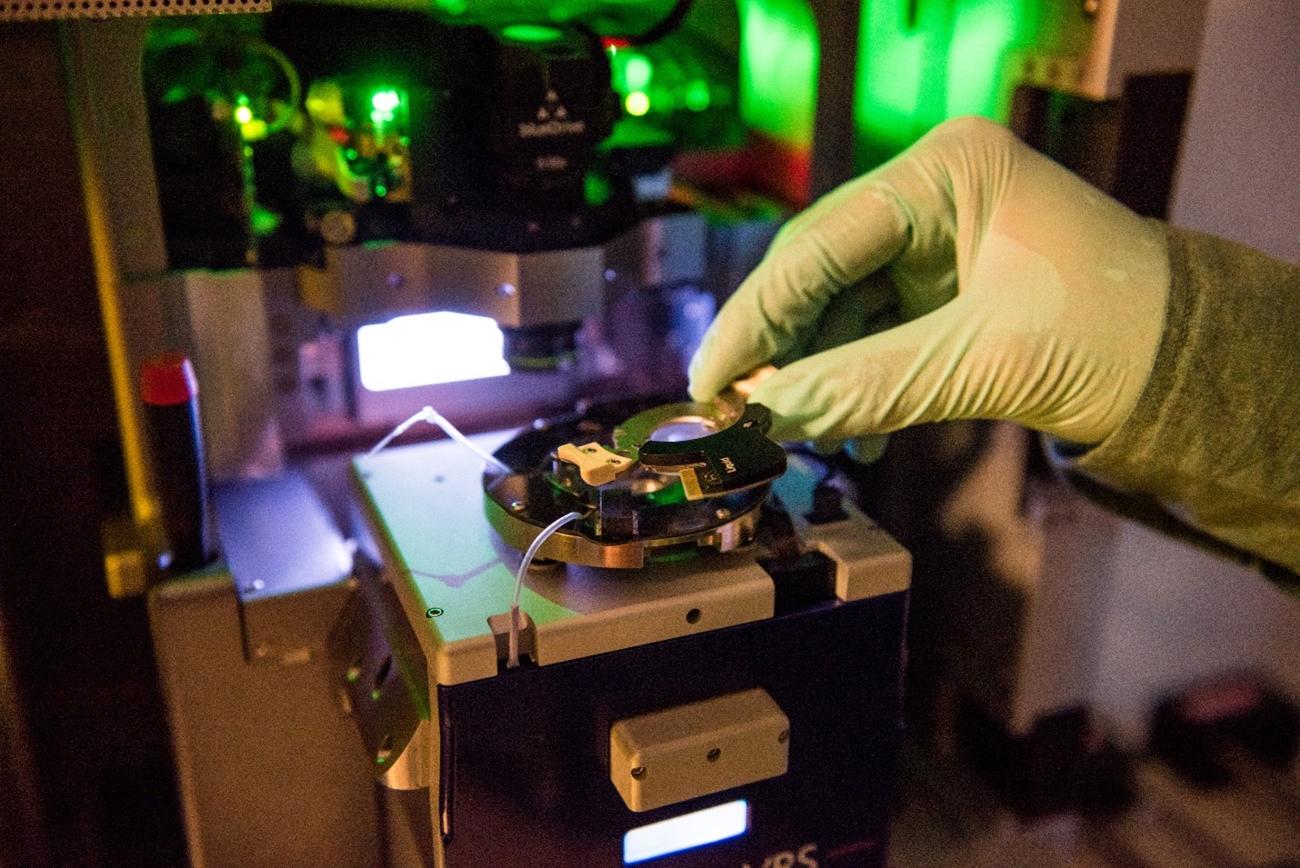 Hand placing a sample onto an AFM