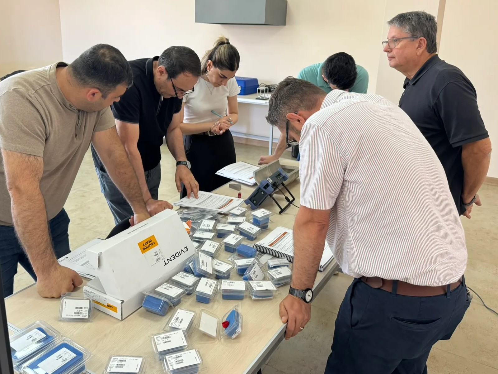 PNNL experts and Armenian participants review ultrasonic testing equipment and training materials - June 2026