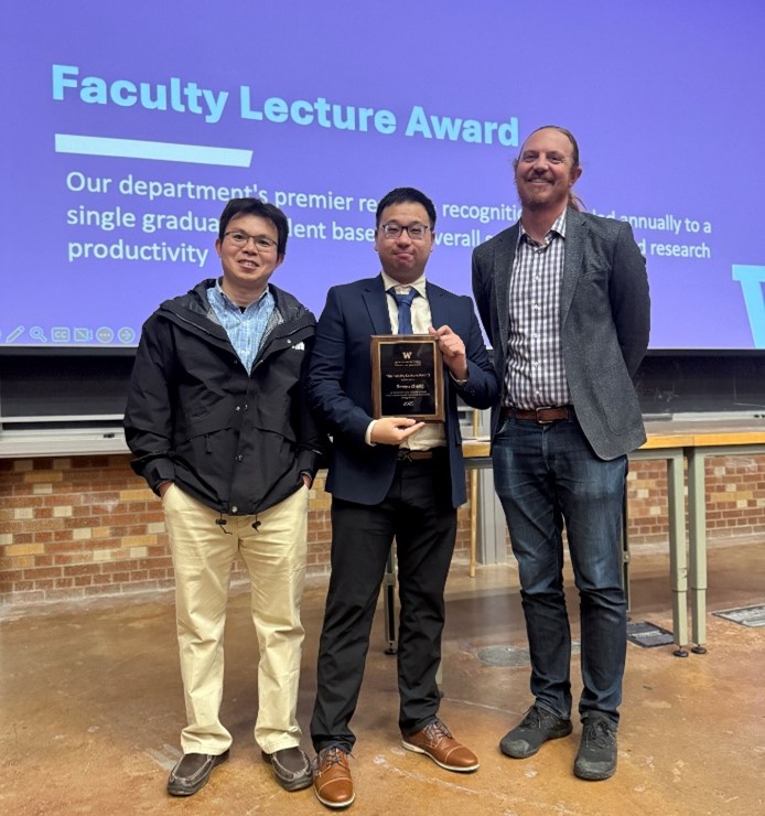 Photograph of three men at an awards presentation