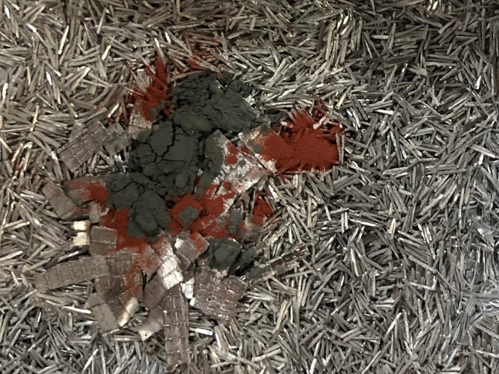 A pile of scrap aluminum with raw metal elements added on top