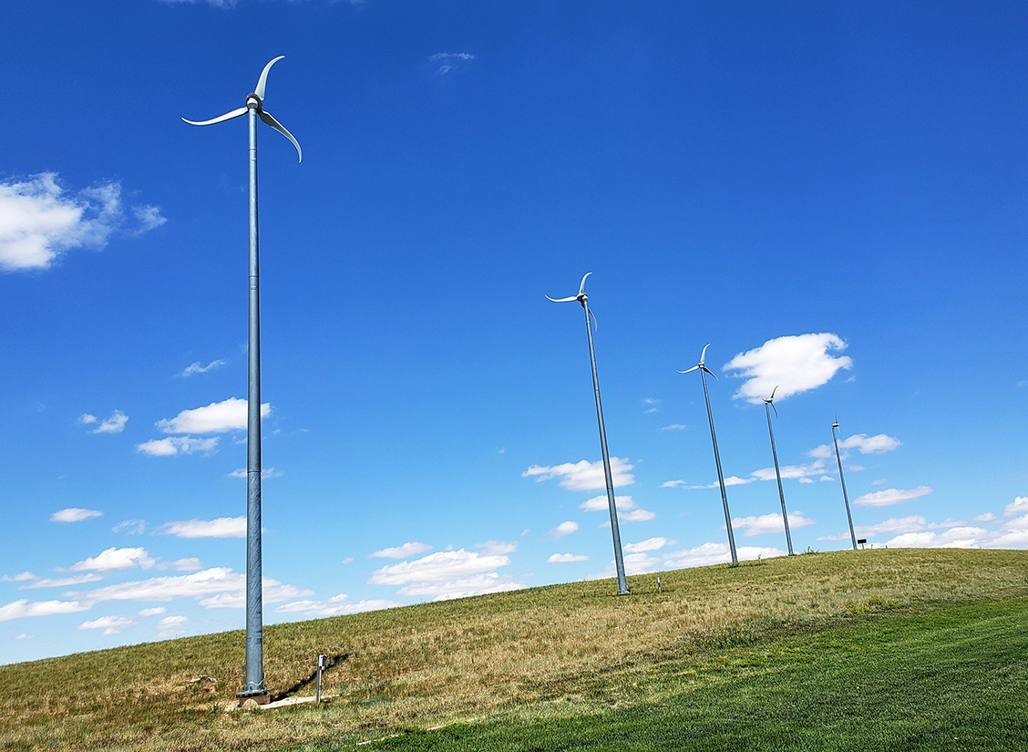 Distributed wind turbines in a field.