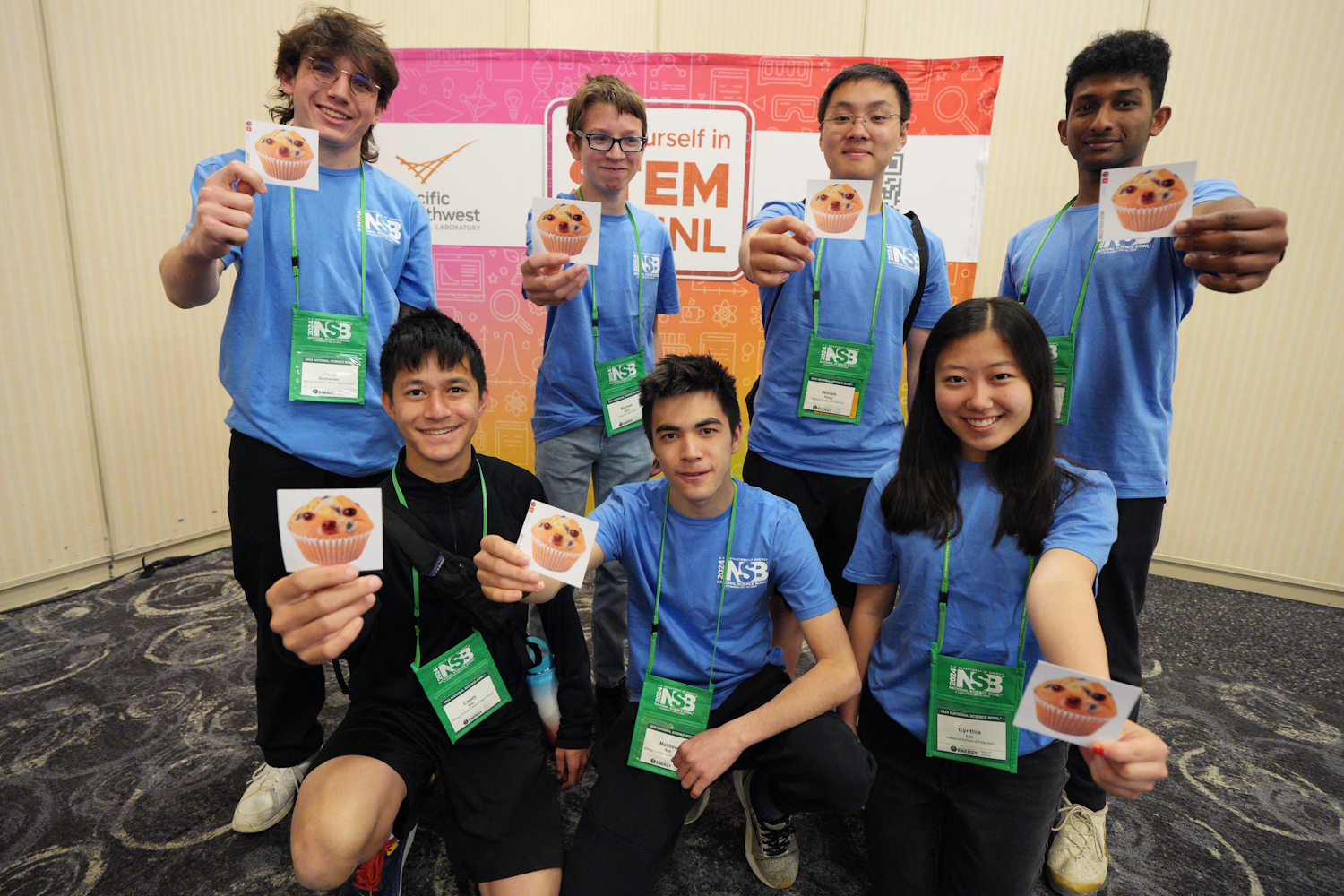 Students holding pictures of a dog/muffin hybrid