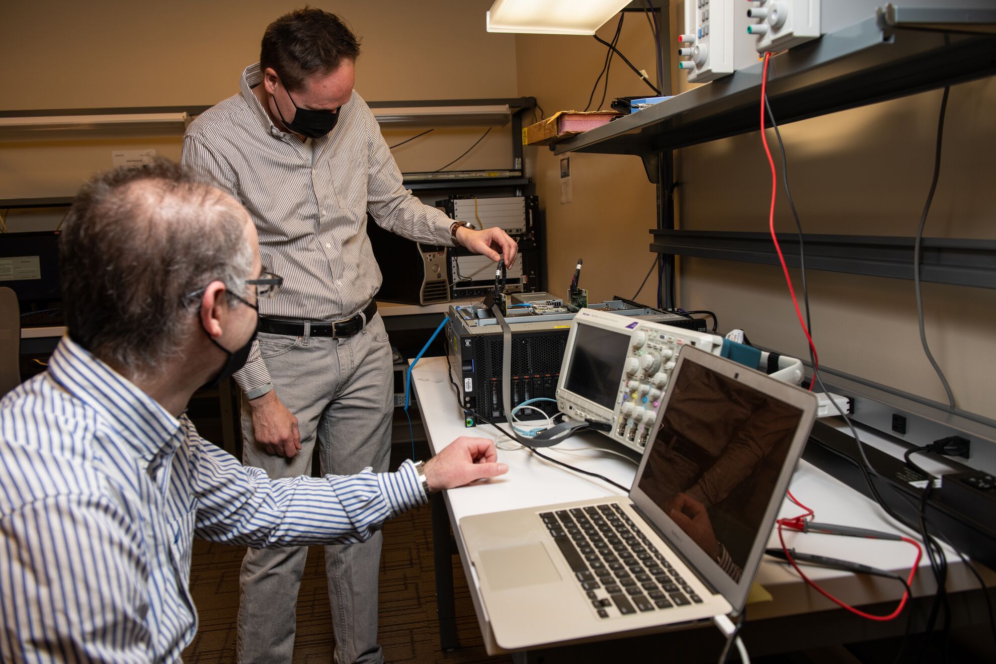Two researchers working with computing equipment