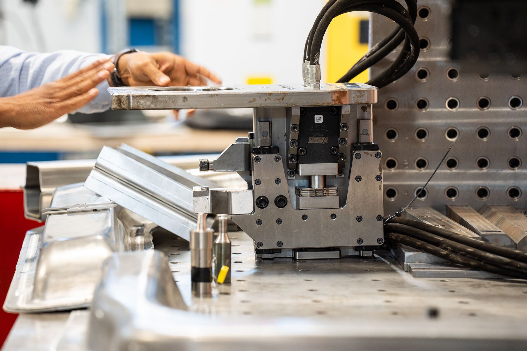 The current prototype self-fixturing friction stir attachment resting on a work surface.