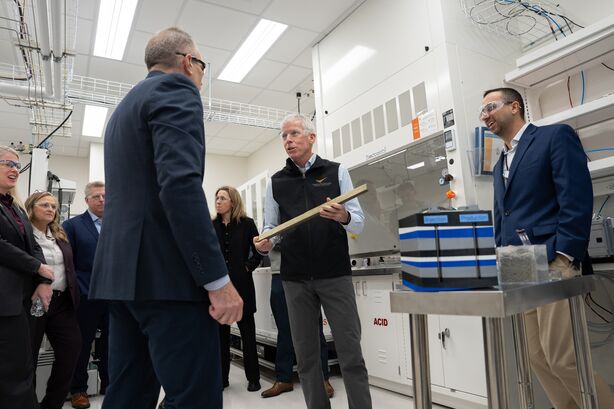Secretary of Energy Chris Wright talks to researchers about advanced materials in a lab