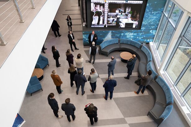 An overhead view of a group of people standing in the spacious lobby of the Grid Storage Launchpad