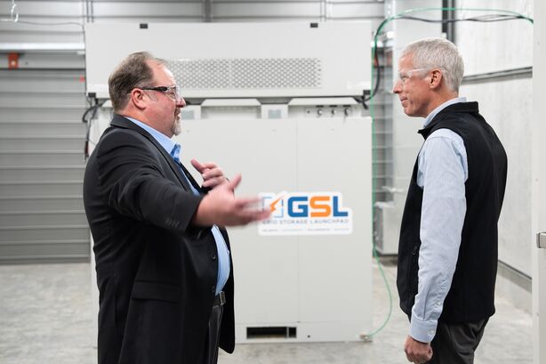 Secretary of Energy Chris Wright and GSL director Court Corely talk in a battery room at the Grid Storage Launchpad