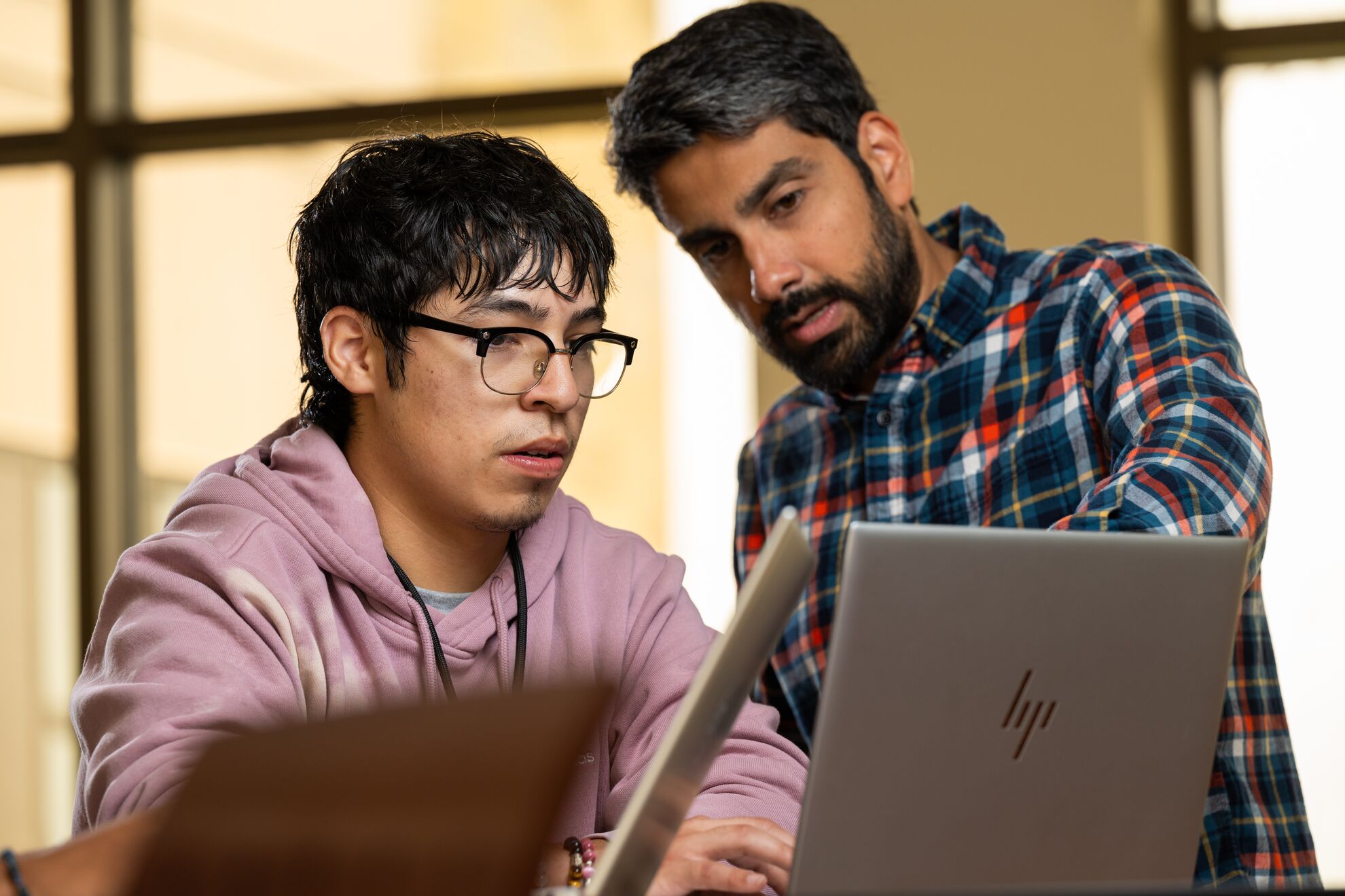 Miguel Palomino and Richard Saldanha looking together at a computer screen