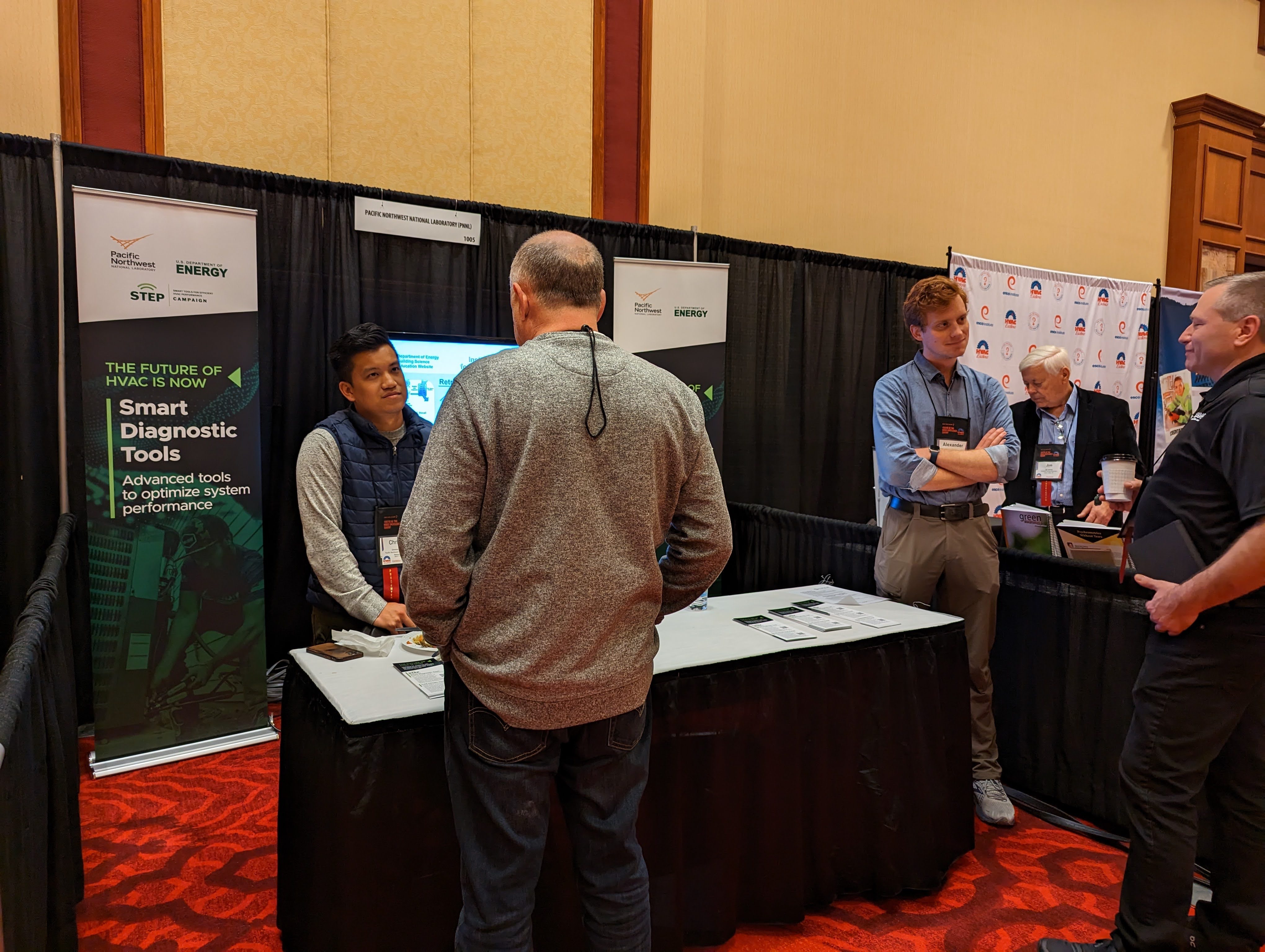 PNNL and DOE engineers discuss Energy Skilled with heating, ventilation, and air conditioning instructors at a conference. (Photo by Jamie Kono | PNNL)