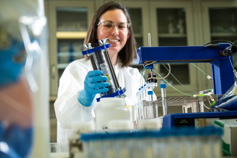 Hilary Emerson holds column in laboratory 