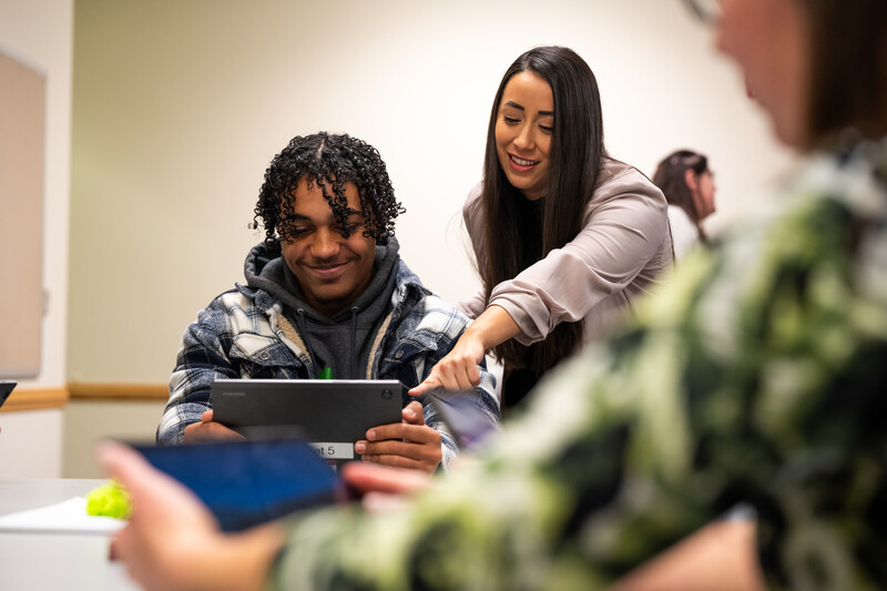 Chelsea Gonzales points at tablet of Columbia Basin College student to teach what is happening on the screen.