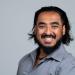 Animesh Pattanayak is pictured from the shoulders up, smiling toward the camera