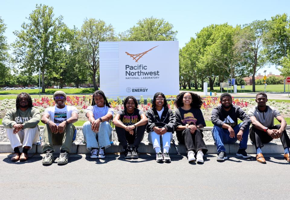 8 MSIPP interns in front of a PNNL campus sign.