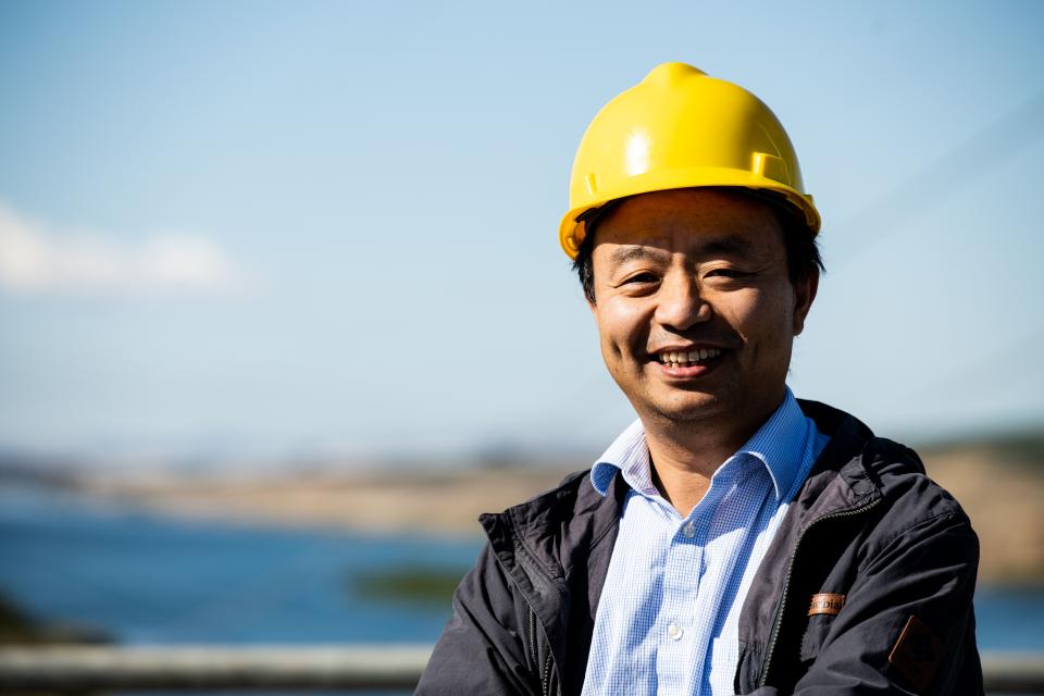 Man outside in a yellow hard hat