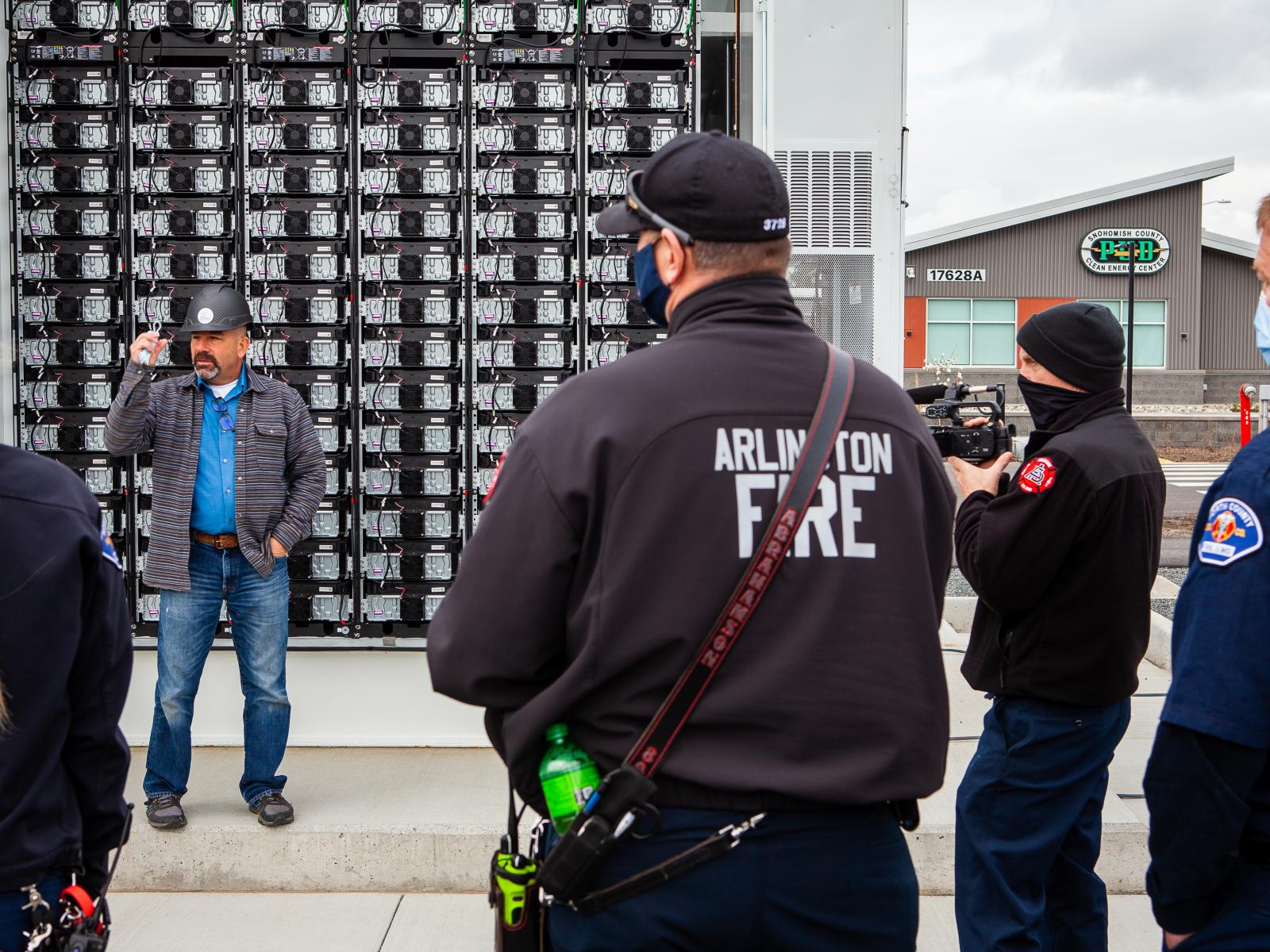 Matt Paiss explaining operations and safety aspects about Li-ion batteries to an Arlington FD firefighter