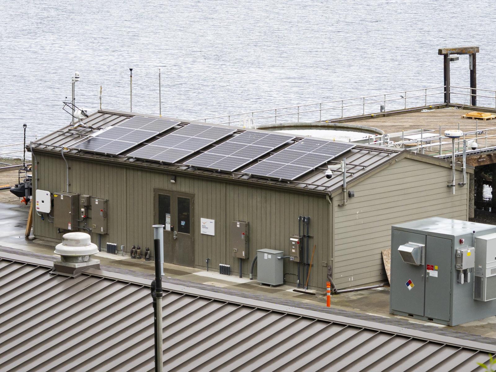 Solar panels on top of a building on the coast of Sequim bay, connected to energy microgrid infrastructure