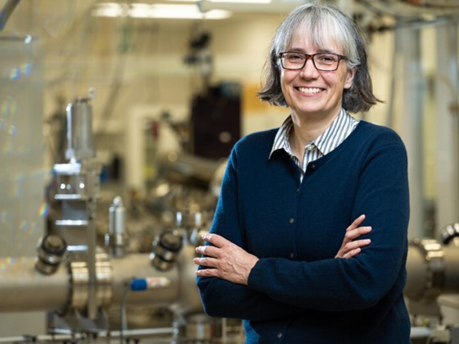 Photograph of Elke Arenholz standing inside a science facility room