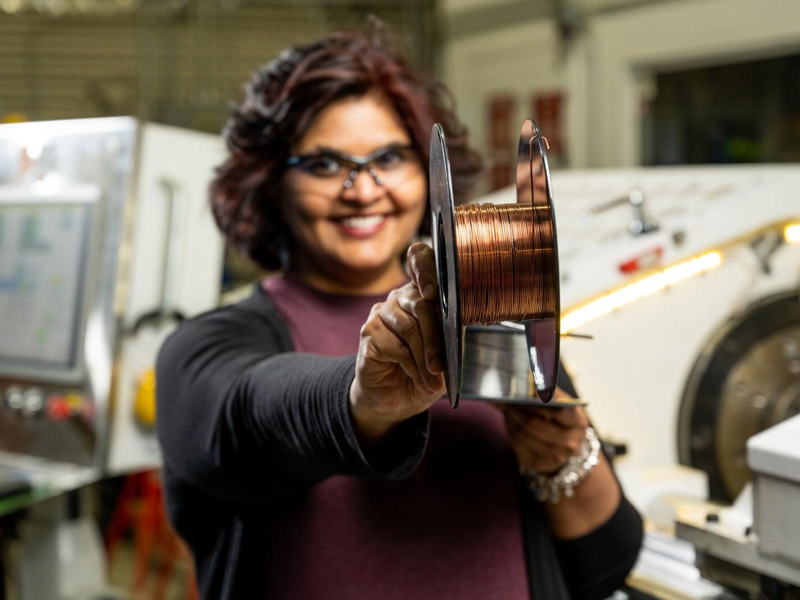 Keerti Kappagantula shows a roll of copper wire